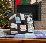 Set of Winter & Christmas Stickers on Laptop in front of Christmas Tree
