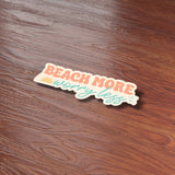 Beach More Worry Less Cute Quote Sticker on Wood Desk in Office