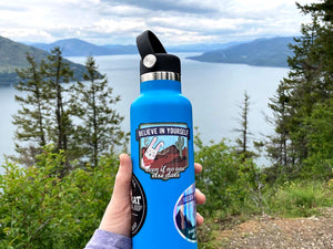 Believe in Yourself Jackalope Sticker on Hydroflask in front of Lake Pend Orielle in North Idaho