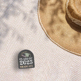 Class of 2025 Graduation Sticker on Beach Blanket Outdoors