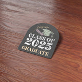 Class of 2025 Graduation Bumper Sticker on Wood Desk in Office
