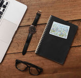 Cute Columbine Flower Colorado Sticker on Journal with Watch and Laptop on Wood Desk in Office