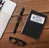 Mizzou Sticker on Journal with Laptop and Watch