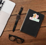 Oh Snap Gingerbread Man Christmas Sticker on Journal with Laptop and Watch on Wood Desk in Office