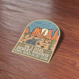 On a Dark Desert Highway Southwest Southern California Bumper Sticker on Wood Desk in Office