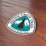 Pacific Crest Trail Marker Bumper Sticker on Wood Desk in Office