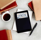 Syracuse New York License Plate Sticker on Kindle eReader with Books and Coffee Mug