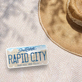 Rapid City South Dakota License Plate Sticker Outdoors on Blanket