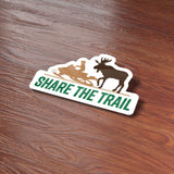 Share the Trail Moose Snowmobile Bumper Sticker on Wood Desk