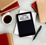 Abilene Texas License Plate Sticker on Kindle eReader with Books and Coffee Mug