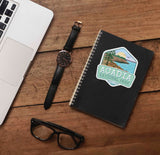 Acadia National Park Maine Sticker on Journal with Laptop and Watch on Wood Desk in Office