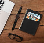 Augusta Georgia Sticker on Journal with Laptop and Watch on Wood Desk in Office