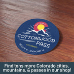 Cottonwood Pass Decal on Wood Desk. Find tons more Colorado stickers with CO cities, Rocky Mountain Passes, & 14ers in our shop