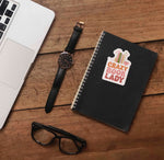 Crazy Book Lady Book Lover Sticker on Journal with Laptop and Watch on Wood Desk in Office