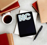 Cute Dogwood NC State Flower North Carolina Sticker on Kindle eReader Tablet with Books and Coffee Mug