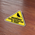 Easily Distracted by Birds Funny Birding Bumper Sticker on Wood Desk in Office