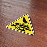 Easily Distracted by Birds Funny Birding Bumper Sticker on Wood Desk in Office