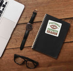 Football is My Favorite Season College Football Sticker on Journal with Macbook and Watch on Wood Desk in Office