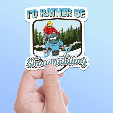 I'd Rather Be Snowmobiling Sticker held in hand