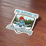 I'd Rather Be Snowmobiling Sticker on wood background