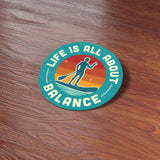 Life is All About Balance Paddleboard Sticker on Wood Desk in Office