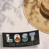 Lost on Purpose Outdoor Adventure Sticker on Beach Blanket