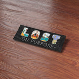 Lost on Purpose Outdoor Bumper Sticker on Wood Desk in Office