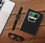 Waterfowl Feather Pattern Sticker on Journal with Laptop and Watch on Wood Desk in Office