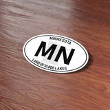 White Oval Minnesota Sticker on Wood Desk in Office