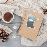 Snowmobile Minnesota Sticker on Journal with Mug of Tea and Winter Sweater