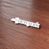 Cute Heart New York Sticker on Wood Desk in Office