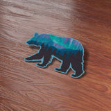  Cute Northern Lights Bear Bumper Sticker on Wood Desk in Office