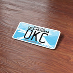 OKC Bumper Sticker on Wood Desk in Office