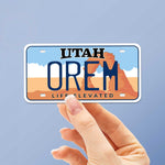 Orem UT Sticker in Hand with Blue Background