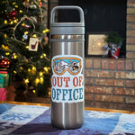 Out of Office Sticker on Water Bottle in Front of Christmas Tree