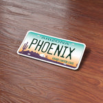 Phoenix Arizona License Plate Sticker on Wood Desk