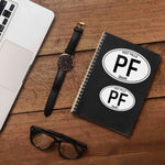 Post Falls North Idaho White Oval Stickers on Journal with Macbook