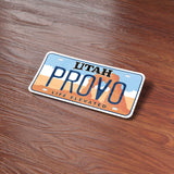 Provo Utah License Plate Bumper Sticker on Wood Desk in Office