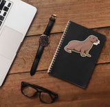 Cute Sea Otter Sticker on Journal with Laptop and Watch on Wood Desk in Office