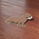 Cute Sea Otter Sticker on Wood Desk in Office