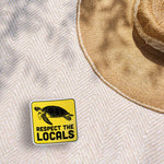 Respect the Locals Sea Turtle Bumper Sticker on Beach Blanket Outdoors