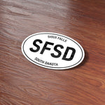 Sioux Falls South Dakota White Oval Bumper Sticker on Wood Desk in Office