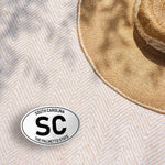 Large SC White Oval South Carolina Bumper Sticker Outdoors on Beach Blanket