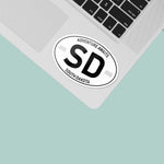 South Dakota White Oval Sticker on Laptop