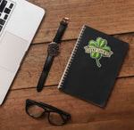 St. Patricks Day Stay Lucky 4 Leaf Clover Sticker on Journal with Macbook and Watch on Wood Desk in Office