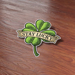 St Patricks Day Stay Lucky 4 Leaf Clover Bumper Sticker on Wood Desk in Office