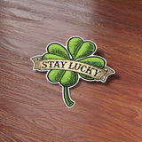 St Patricks Day Stay Lucky 4 Leaf Clover Bumper Sticker on Wood Desk in Office