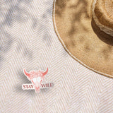 Stay Wild Cattle Skull Cowgirl Sticker Outdoors on Beach Blanket