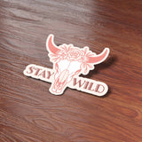 Stay Wild Cattle Skull Cowgirl Sticker on Wood Desk in Office