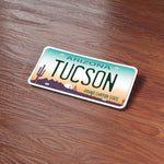 Tucson Arizona License Plate Sticker on Wood Desk